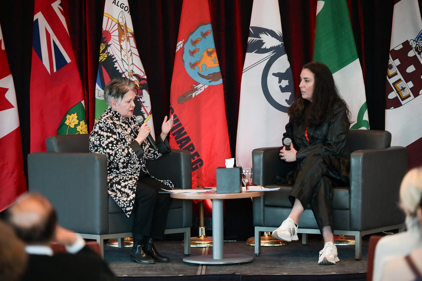 Chancellor Claudette Commanda speaking with Tanya Talaga at the lecture.