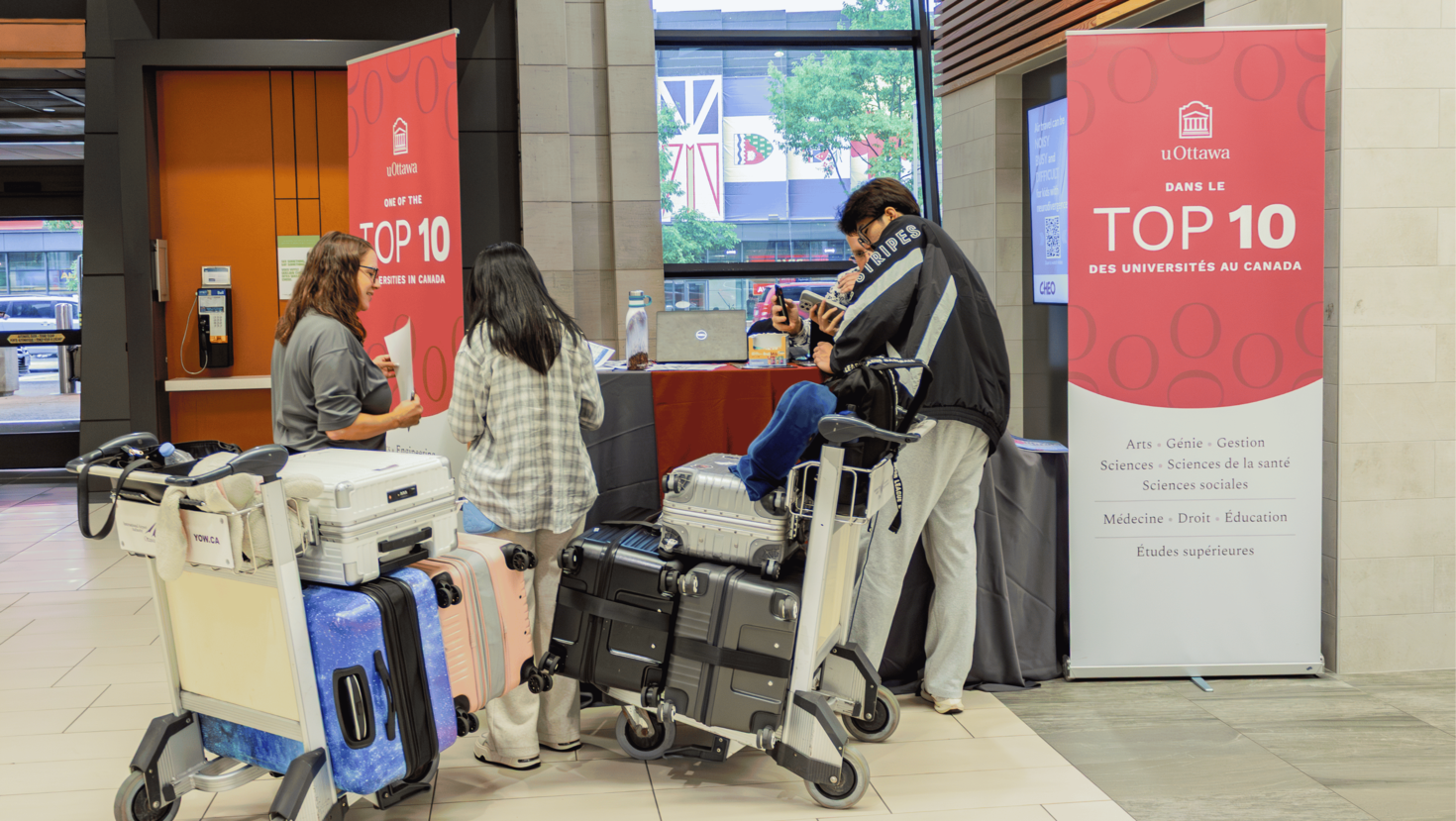 uOttawa staff welcoming new students at the Ottawa Macdonald-Cartier International Airport.