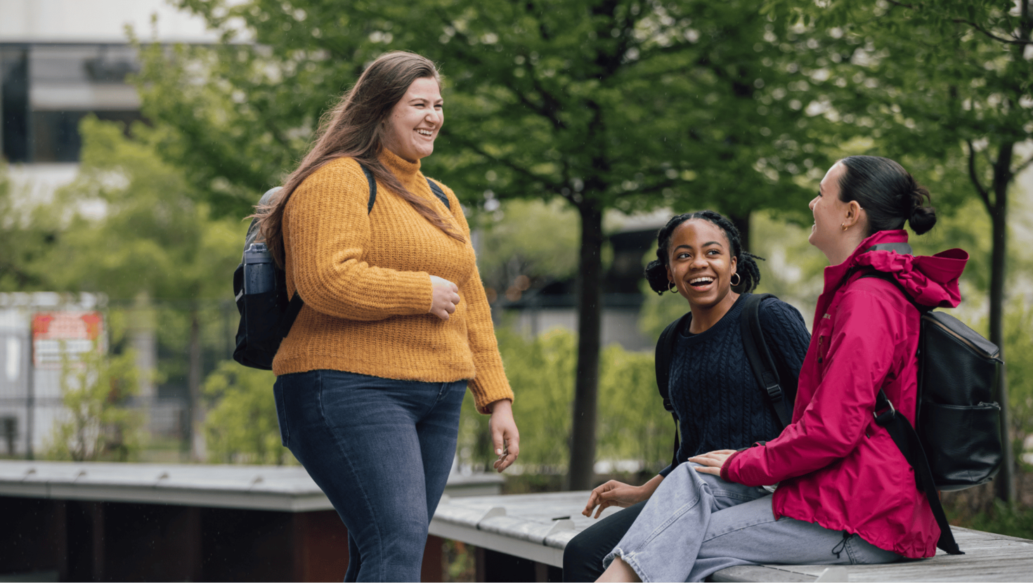 Three uOttawa students laughing and chatting.