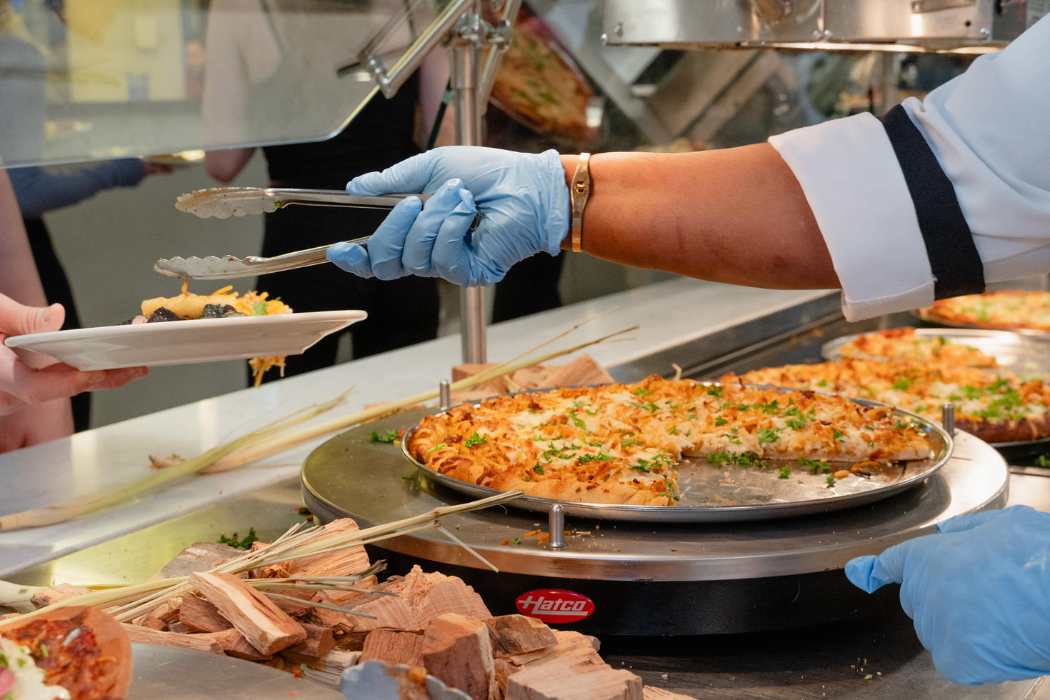 Chef handing Pizza to a student 
