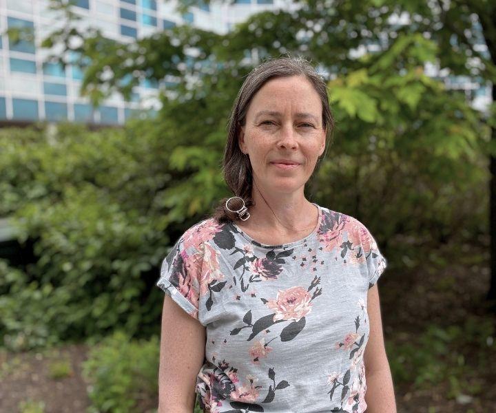 Angela Marsh in front of trees in the D'Iorio courtyard. 