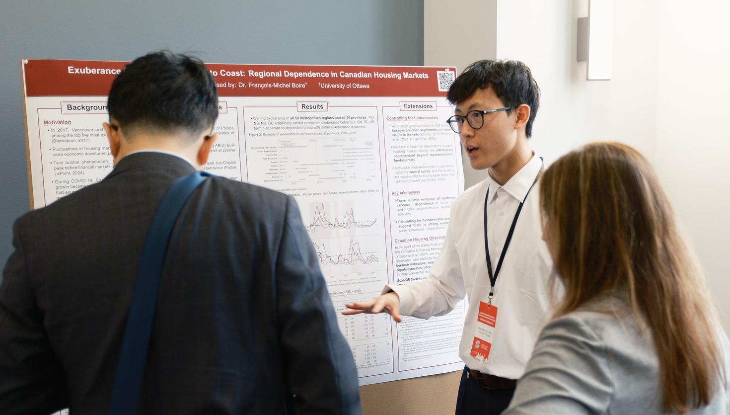Mike Liang presenting his research poster during an event. 