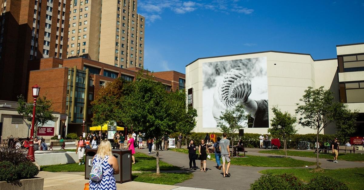 Gigantic mural representing hands reproduced multiple times and superimposed.