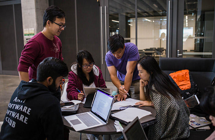 A group of students studying at a table.