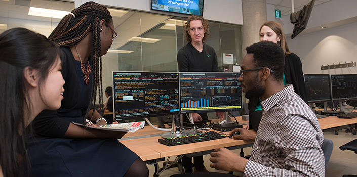 Students studying around a computer.