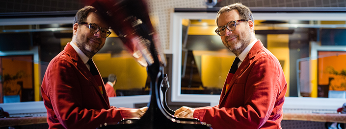 Gilles Comeau seated at a piano